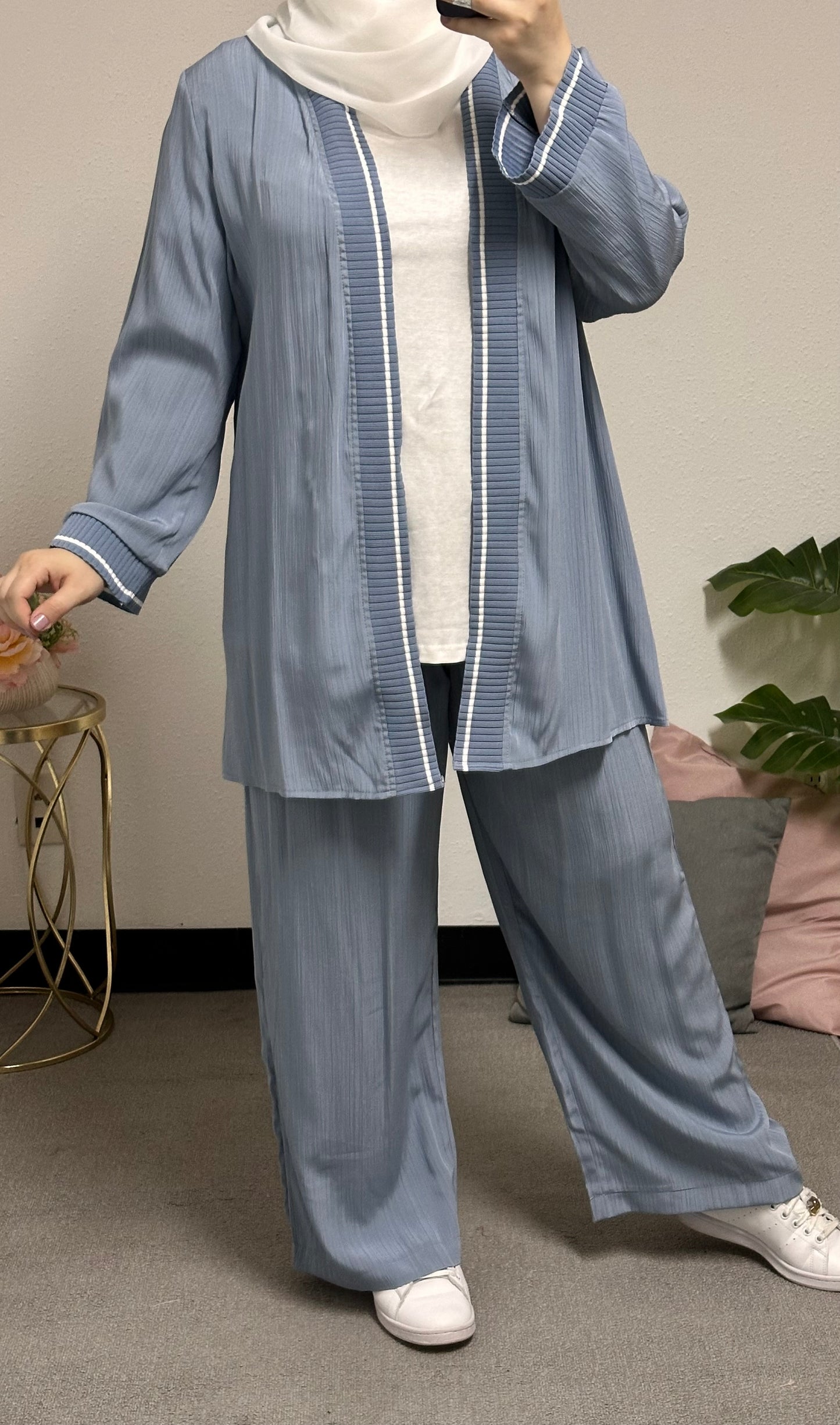 “Three-piece set including a short cardigan, inner blouse, and pants.”