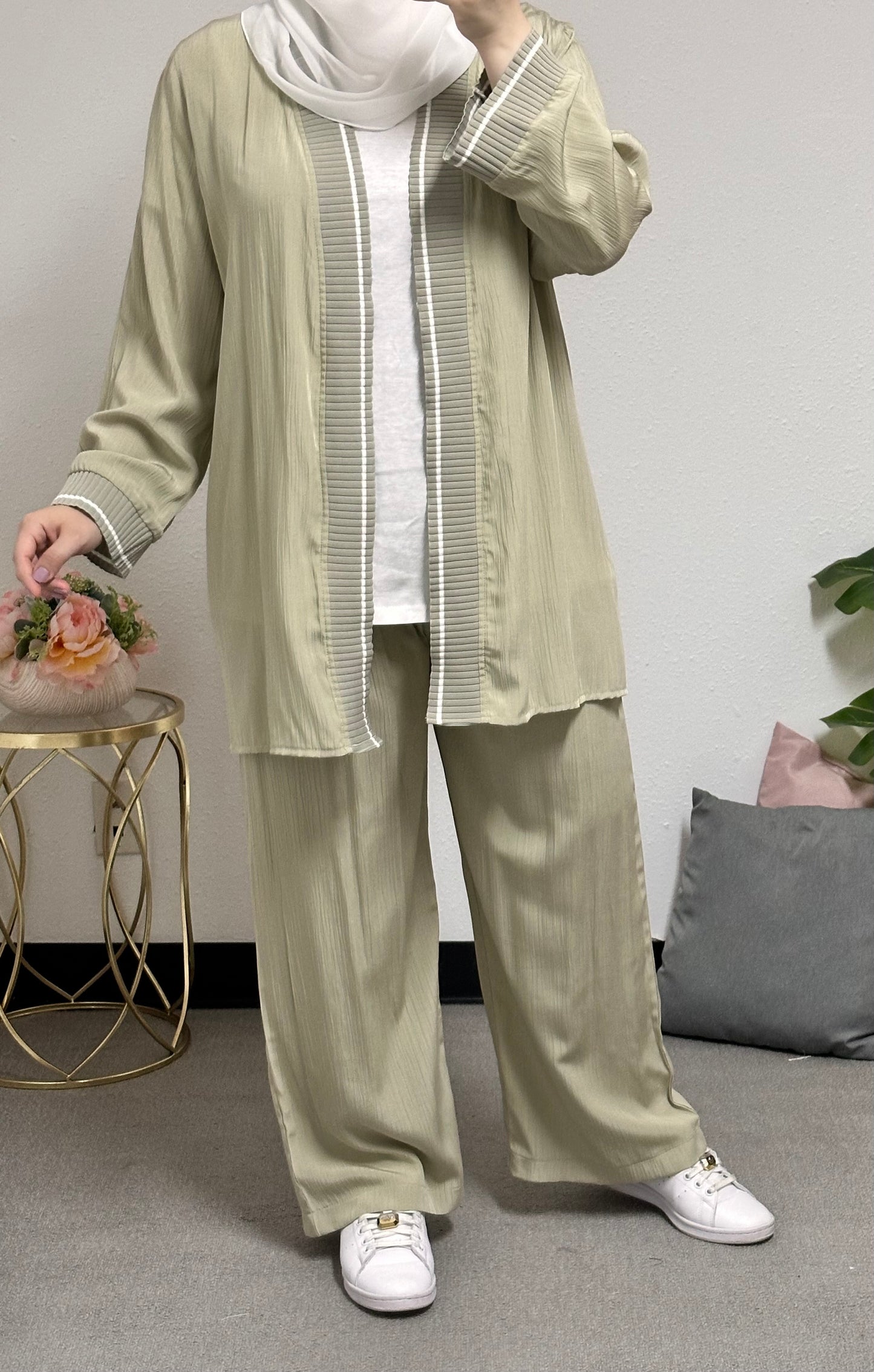 “Three-piece set including a short cardigan, inner blouse, and pants.”