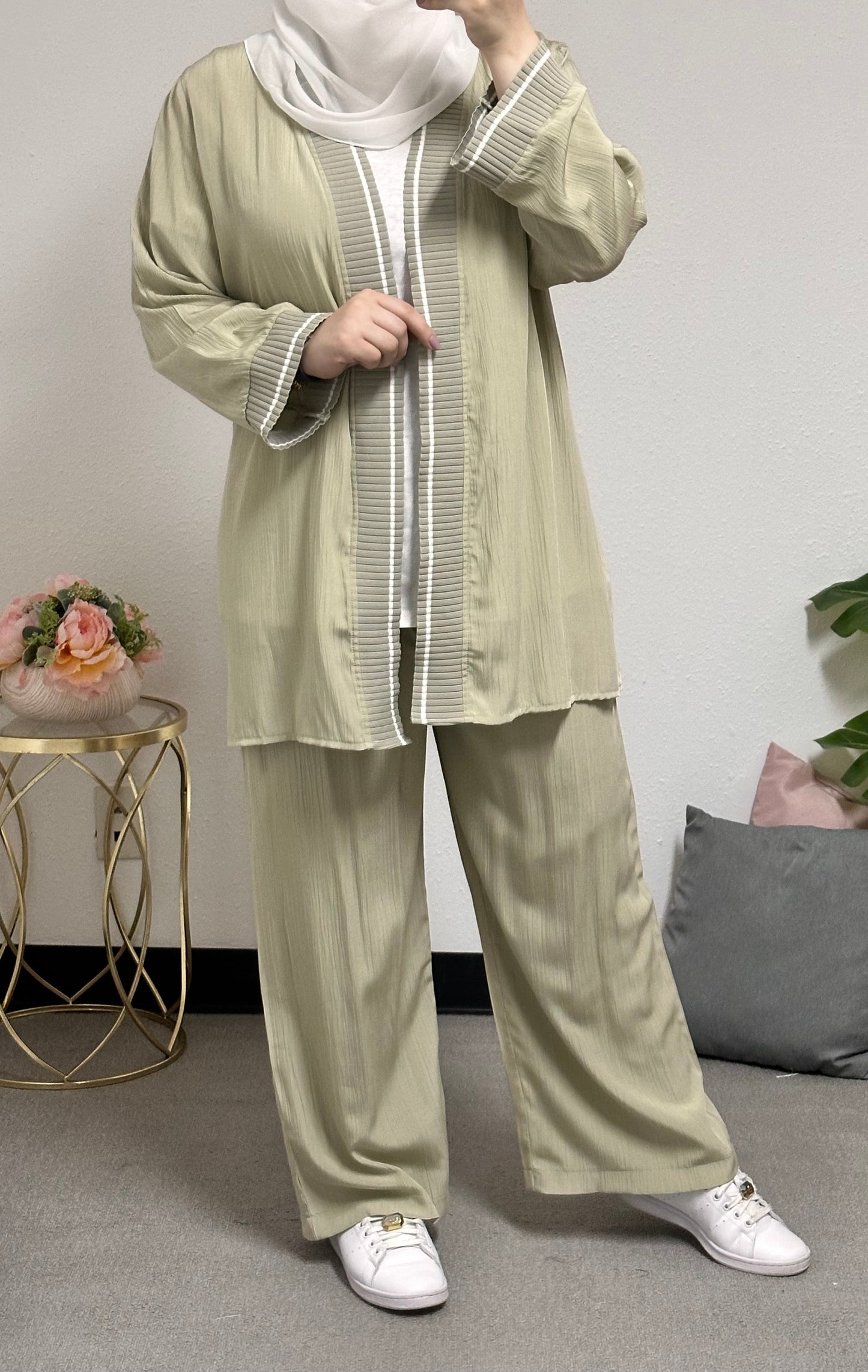 “Three-piece set including a short cardigan, inner blouse, and pants.”